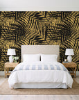 Desert Frond Gilt palm frond wallpaper behind a queen bed in a bright coastal bedroom