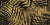 Desert Frond Gilt palm frond wallpaper in black and gold