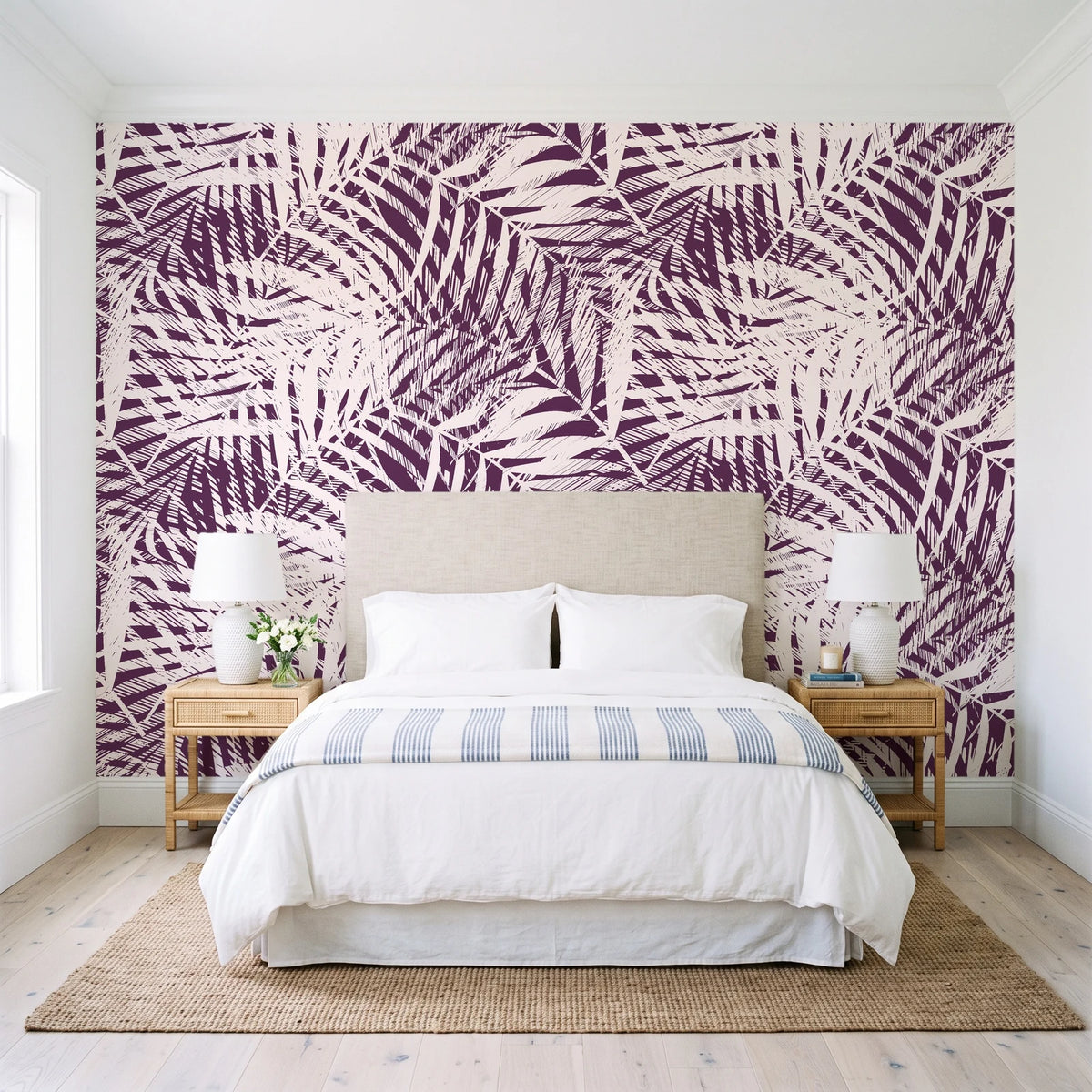 Desert Frond Plum palm frond wallpaper behind a queen bed in a bright coastal bedroom