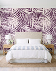 Desert Frond Plum palm frond wallpaper behind a queen bed in a bright coastal bedroom