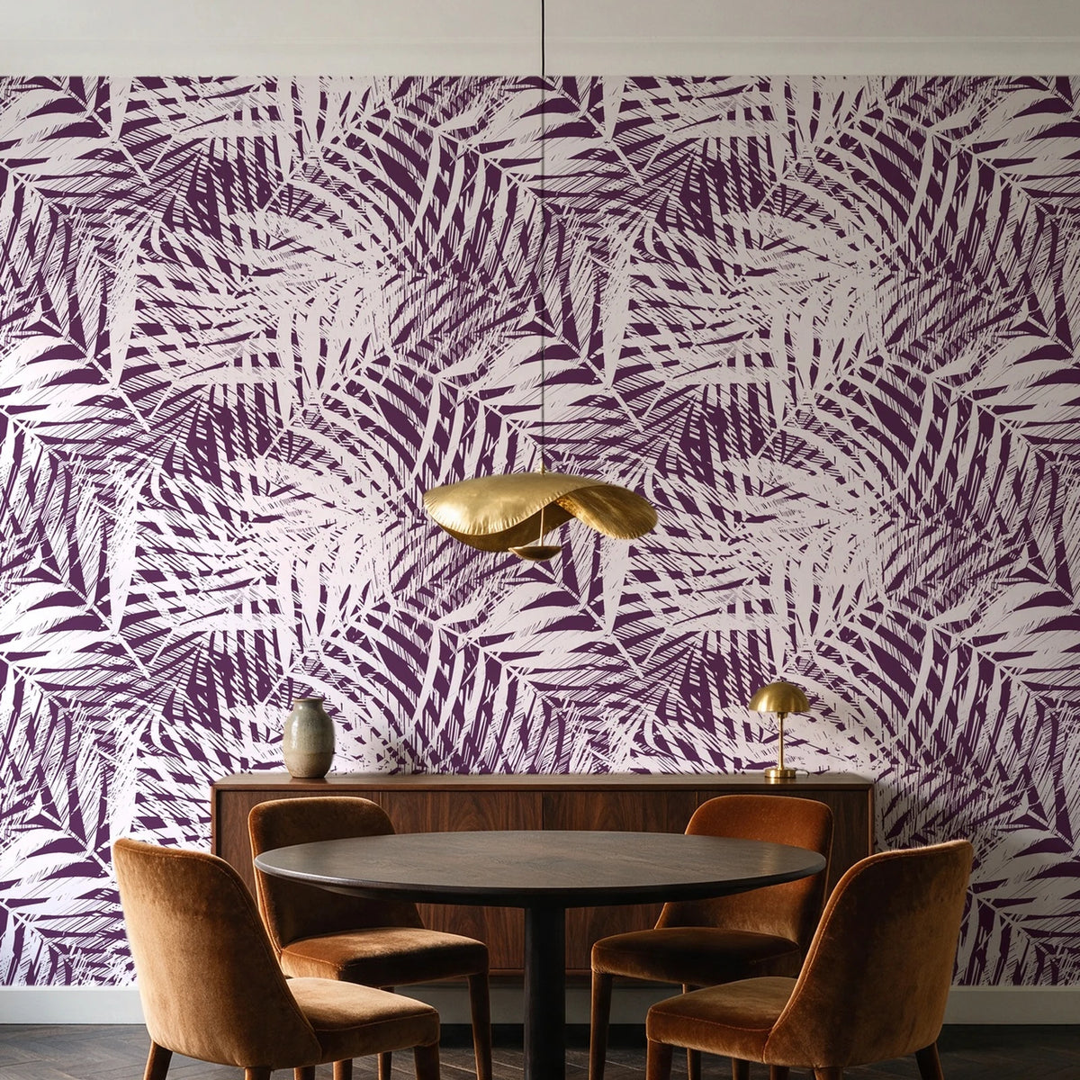 Desert Frond Plum palm frond wallpaper behind a walnut credenza and round table in an elegant dining room