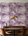 Desert Frond Plum palm frond wallpaper behind a walnut credenza and round table in an elegant dining room