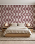 Desert Ritual Oxblood tribal geometric wallpaper behind a low platform bed in a serene Japandi bedroom