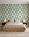 Desert Ritual Sage tribal geometric wallpaper behind a low platform bed in a serene Japandi bedroom