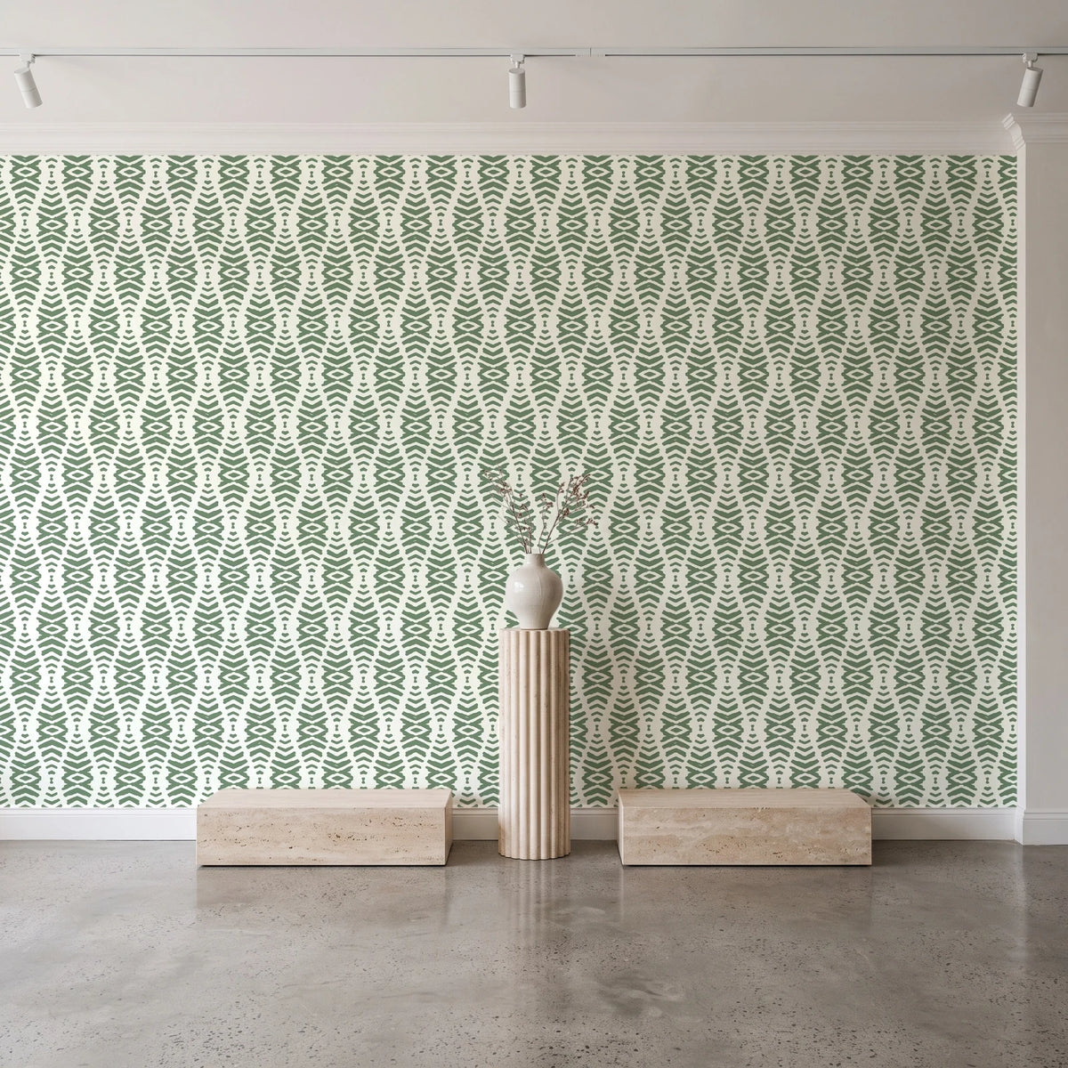 Desert Ritual Sage tribal geometric wallpaper behind a travertine pedestal and vase in a minimal boutique
