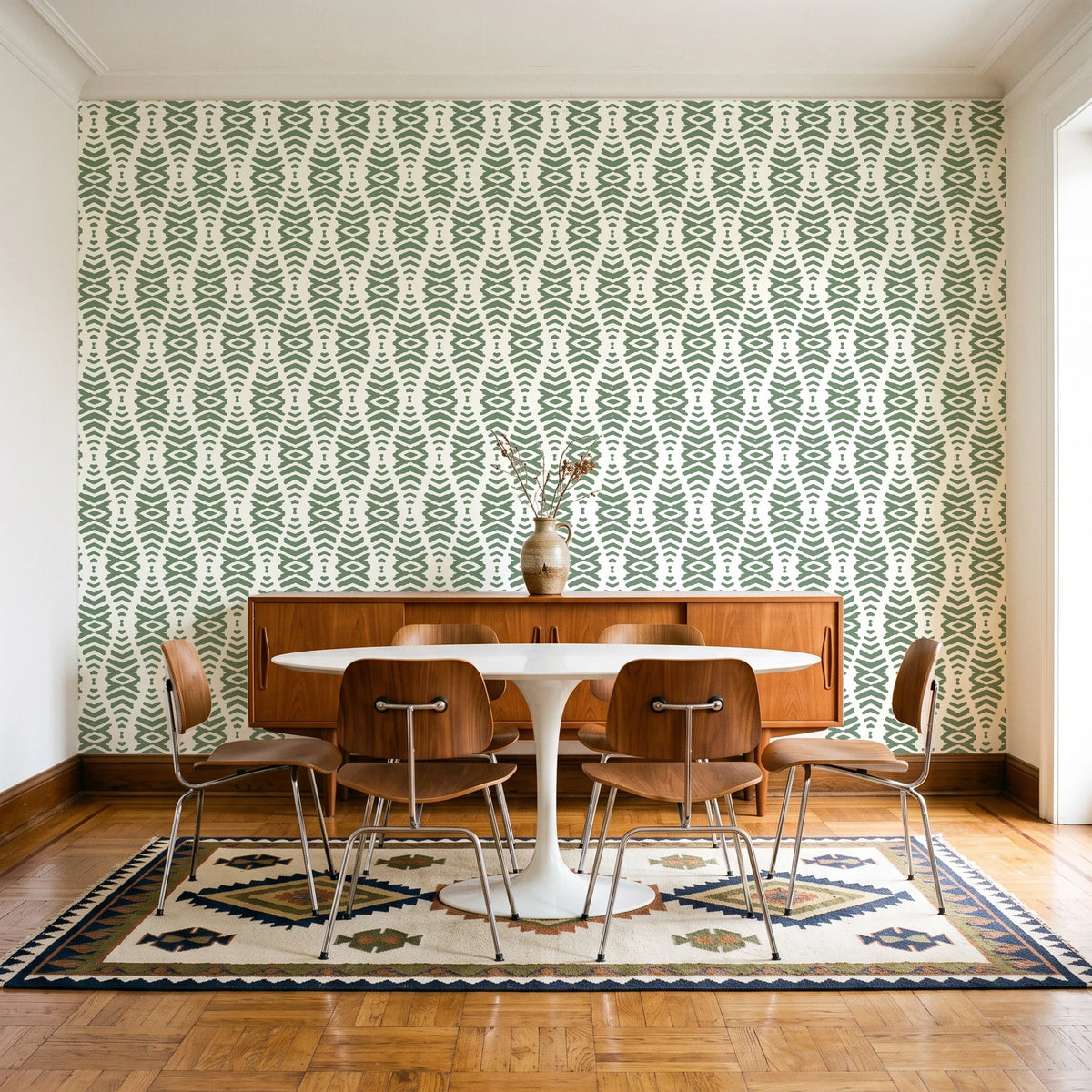 Desert Ritual Sage tribal geometric wallpaper in a mid-century dining room with a teak sideboard and tulip table