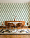 Desert Ritual Sage tribal geometric wallpaper in a mid-century dining room with a teak sideboard and tulip table