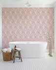 Diamond Echo Bordeaux tribal diamond wallpaper behind a freestanding tub in a bright coastal bathroom