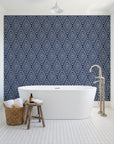 Diamond Echo Midnight tribal diamond wallpaper behind a freestanding tub in a bright coastal bathroom