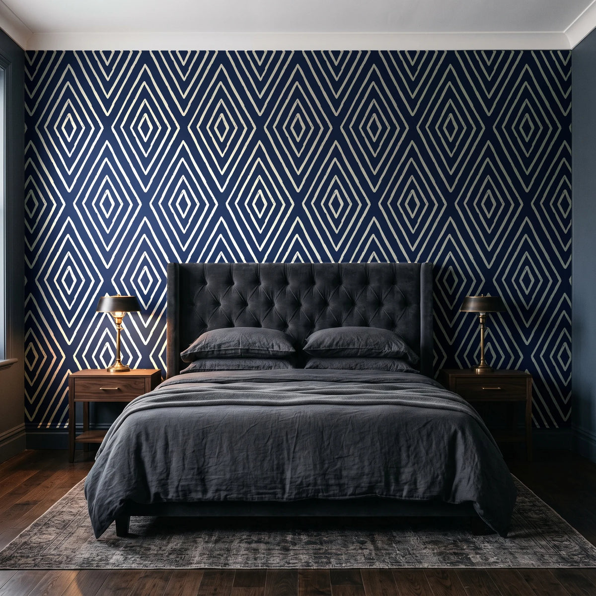 Diamond Echo Midnight tribal diamond wallpaper behind a tufted headboard in a dark, moody bedroom