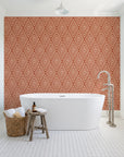 Diamond Echo Terracotta tribal diamond wallpaper behind a freestanding tub in a bright coastal bathroom