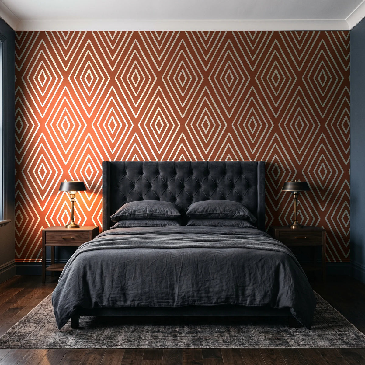 Diamond Echo Terracotta tribal diamond wallpaper behind a tufted headboard in a dark, moody bedroom