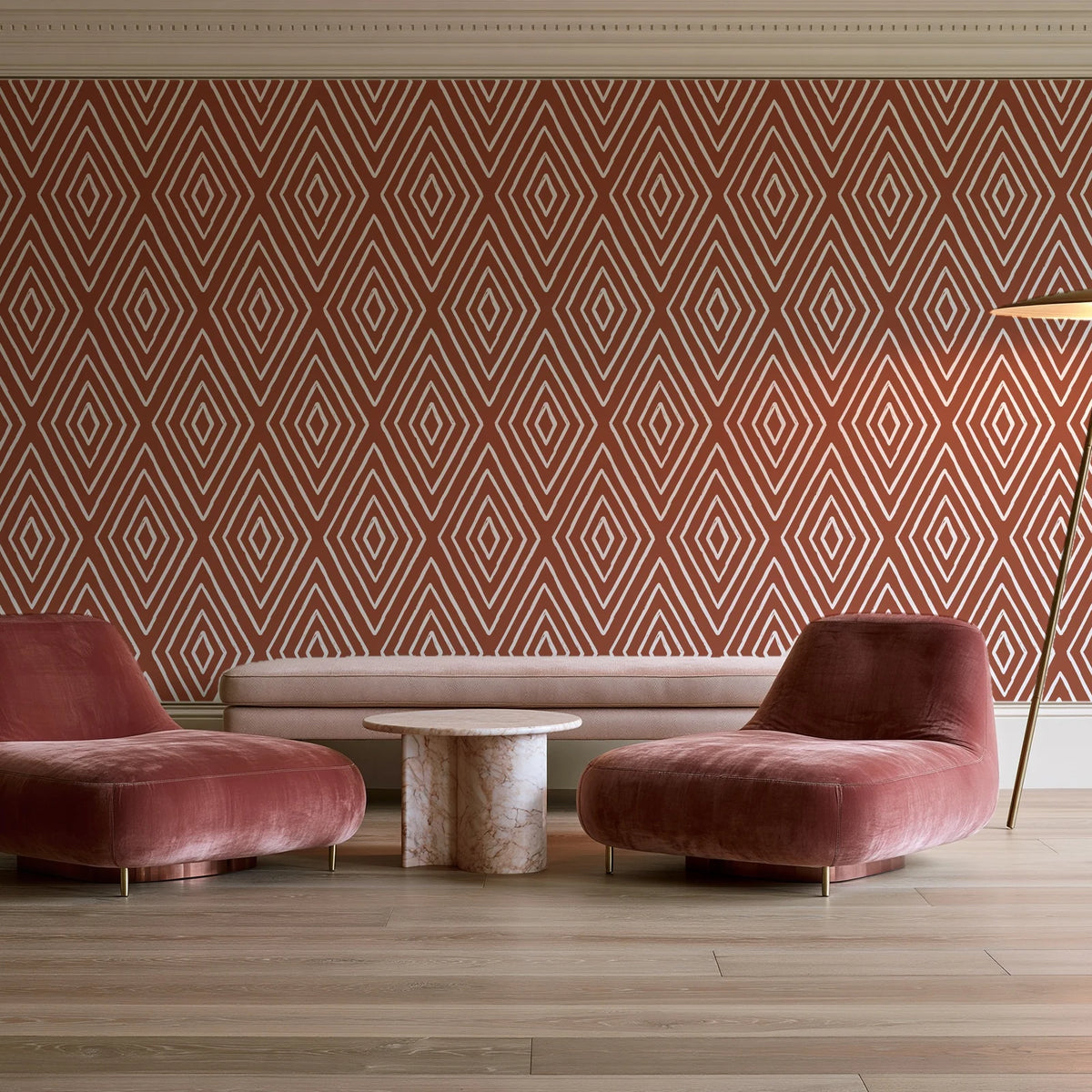 Diamond Echo Terracotta tribal diamond wallpaper in a boutique hotel sitting area