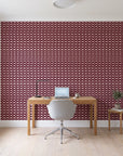 Dot Column Oxblood dotted wallpaper behind a modern oak desk in a bright home office
