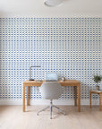 Dot Column Porcelain dotted wallpaper behind a modern oak desk in a bright home office