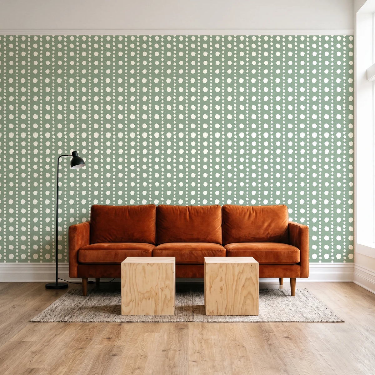Dot Column Sage dotted wallpaper behind a rust velvet sofa in a bright coworking lounge