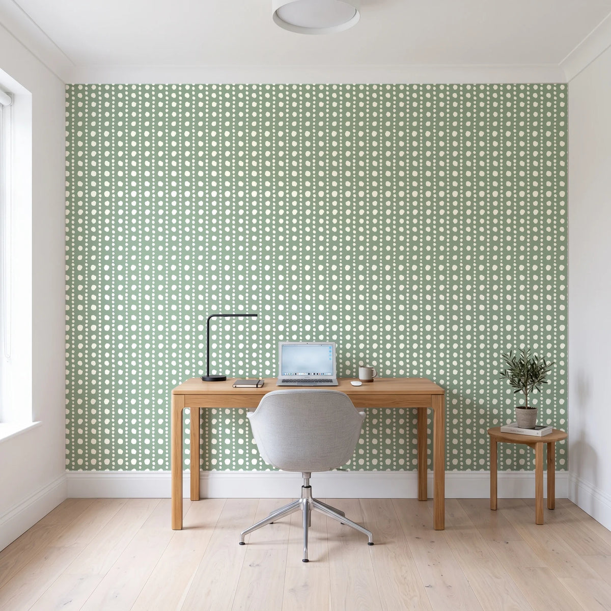 Dot Column Sage dotted wallpaper behind a modern oak desk in a bright home office