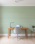 Dot Column Sage dotted wallpaper behind a modern oak desk in a bright home office