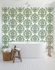 Dreamy Fern Dial Sage fern damask wallpaper behind a freestanding tub in a bright coastal bathroom