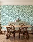 Drifting Petals Emerald abstract petal wallpaper in a farmhouse dining room with a sage sideboard and rustic trestle table