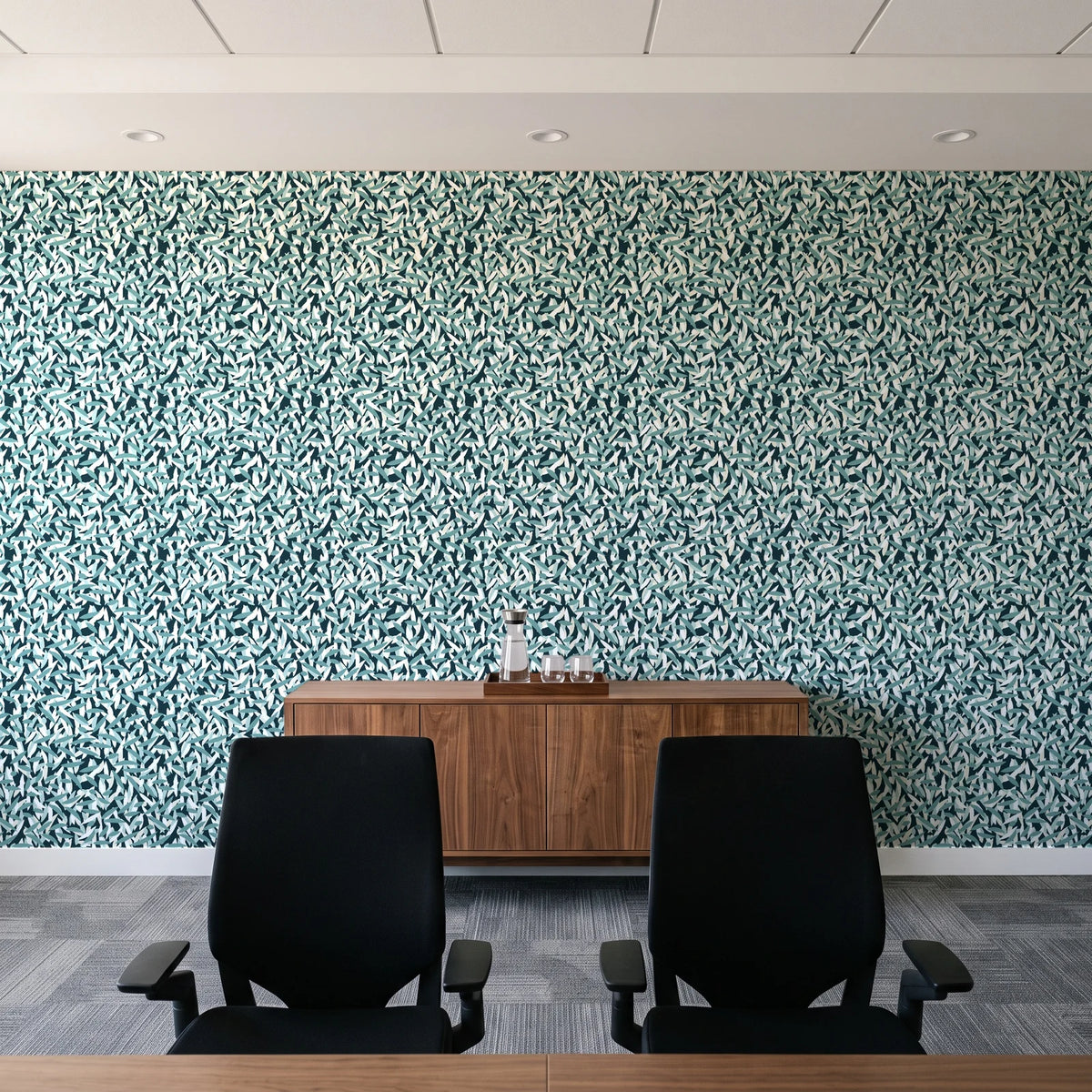 Drifting Petals Lagoon abstract petal wallpaper above a walnut credenza in a modern conference room