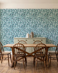 Drifting Petals Lagoon abstract petal wallpaper in a farmhouse dining room with a sage sideboard and rustic trestle table