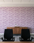 Drifting Petals Plum abstract petal wallpaper above a walnut credenza in a modern conference room