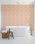 Drifting Petals Terracotta abstract petal wallpaper behind a freestanding tub in a bright coastal bathroom