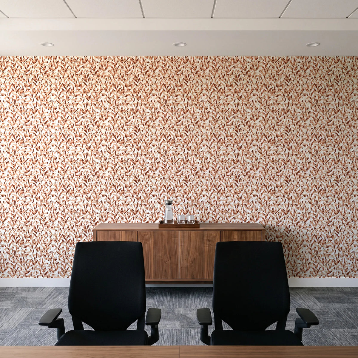Drifting Petals Terracotta abstract petal wallpaper above a walnut credenza in a modern conference room