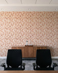 Drifting Petals Terracotta abstract petal wallpaper above a walnut credenza in a modern conference room