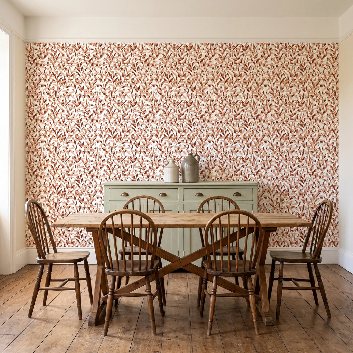 Drifting Petals Terracotta abstract petal wallpaper in a farmhouse dining room with a sage sideboard and rustic trestle table