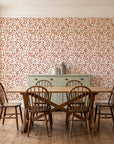 Drifting Petals Terracotta abstract petal wallpaper in a farmhouse dining room with a sage sideboard and rustic trestle table