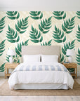 Driftwood Fern Emerald fern frond wallpaper behind a queen bed in a bright coastal bedroom