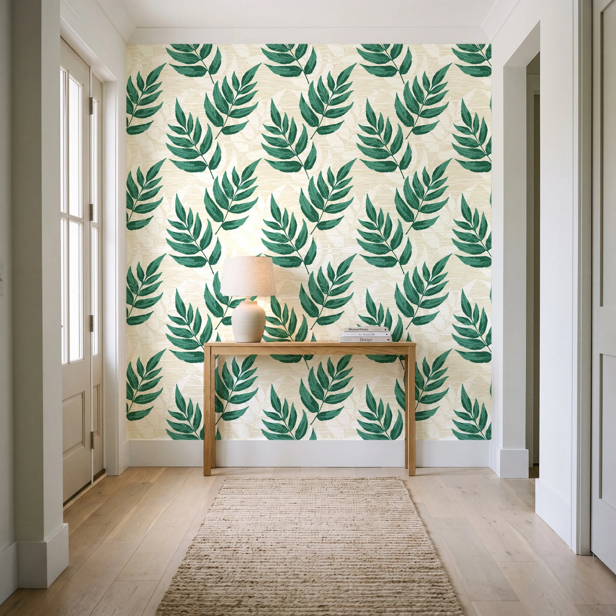 Driftwood Fern Emerald fern frond wallpaper behind a console table in a light entry hallway