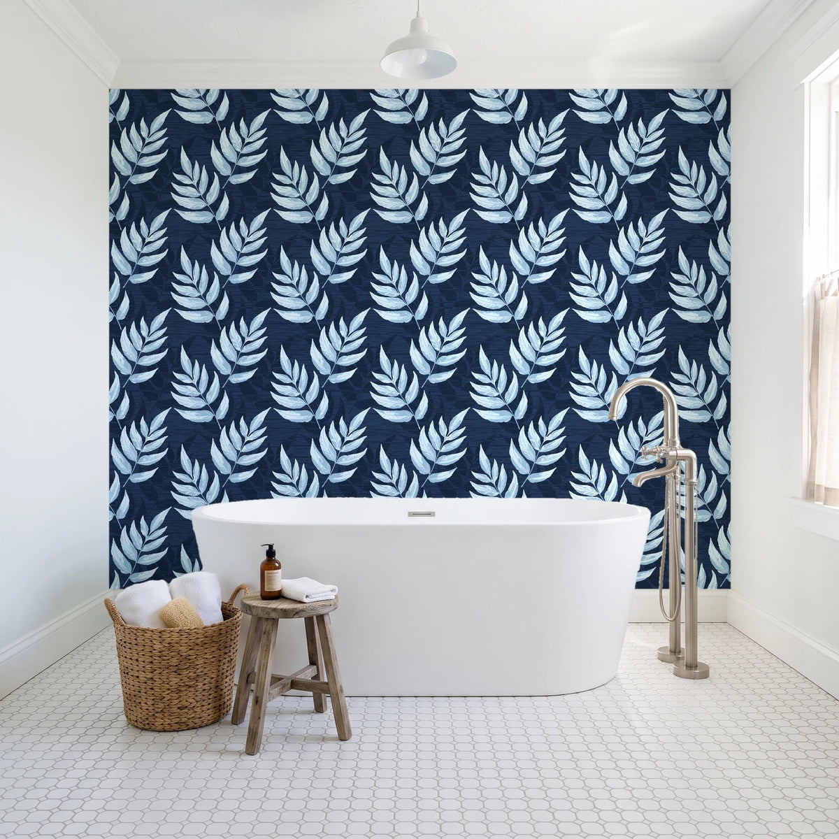 Driftwood Fern Midnight fern frond wallpaper behind a freestanding tub in a bright coastal bathroom