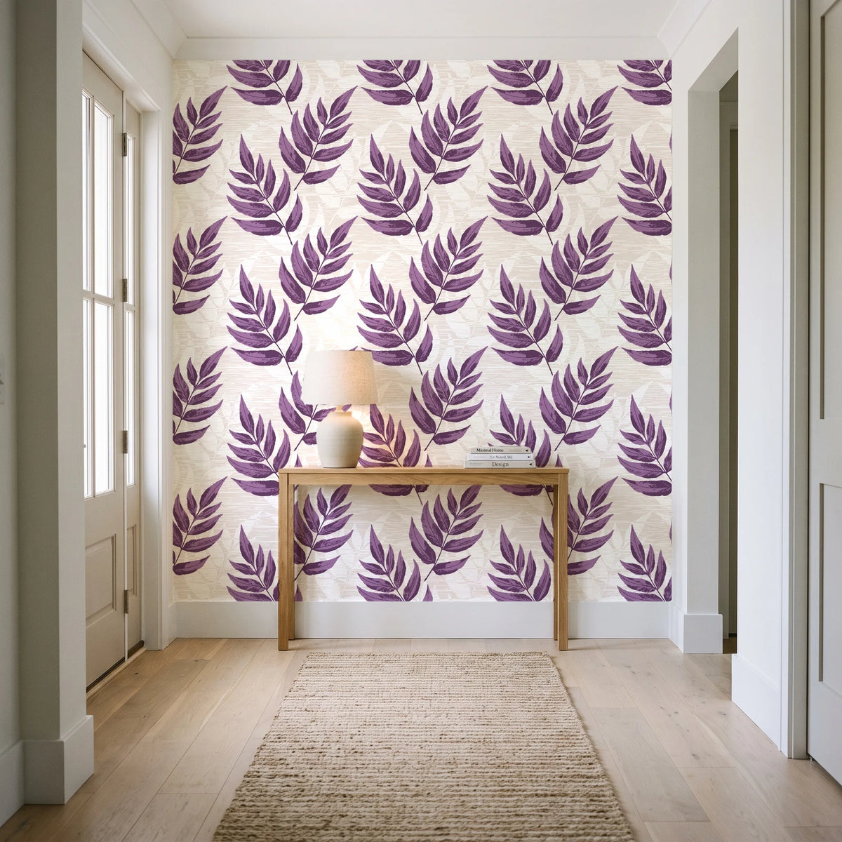 Driftwood Fern Plum fern frond wallpaper behind a console table in a light entry hallway