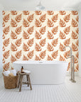Driftwood Fern Terracotta fern frond wallpaper behind a freestanding tub in a bright coastal bathroom
