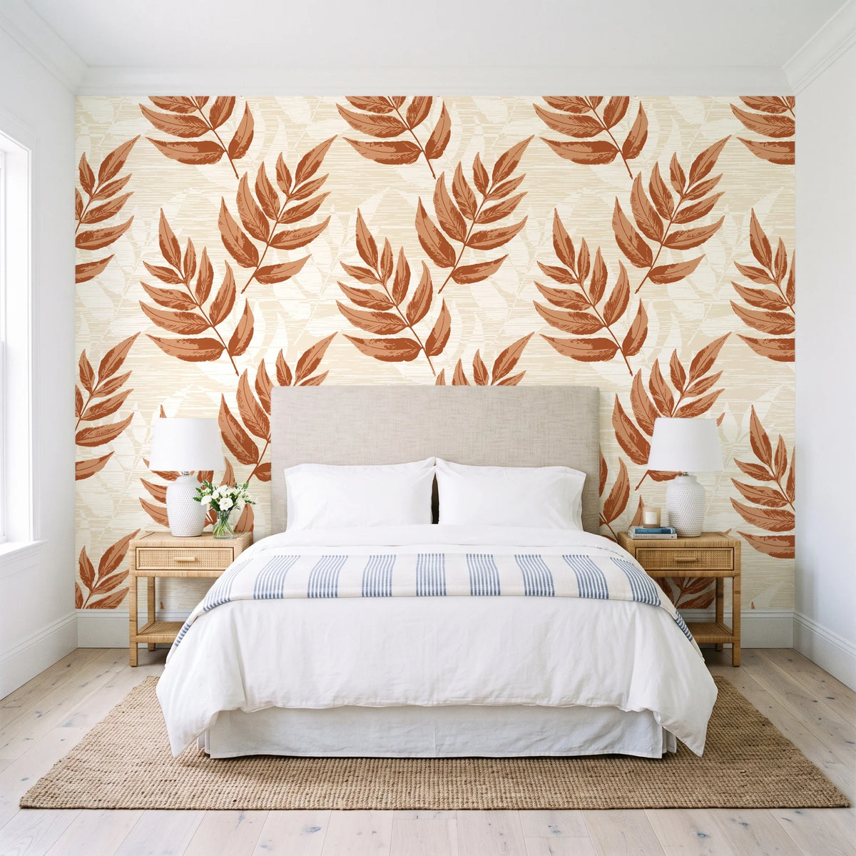 Driftwood Fern Terracotta fern frond wallpaper behind a queen bed in a bright coastal bedroom
