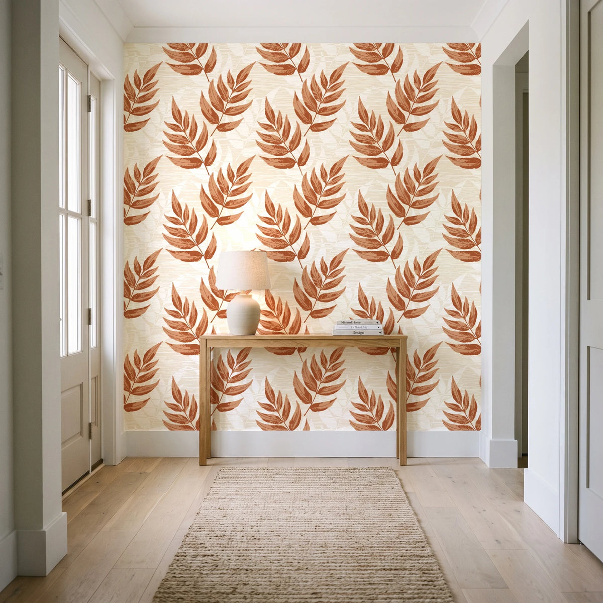 Driftwood Fern Terracotta fern frond wallpaper behind a console table in a light entry hallway