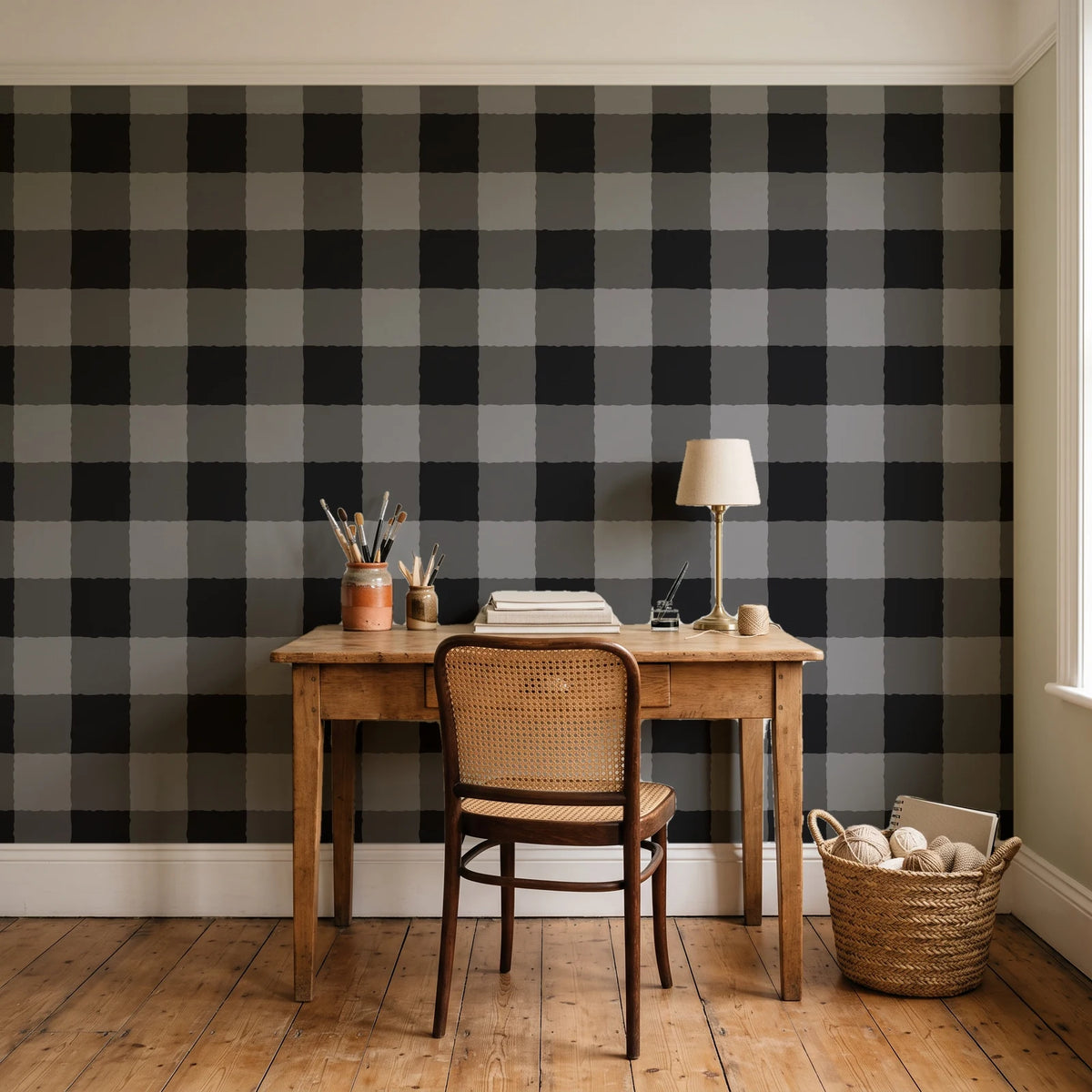 Dune Plaid Charcoal gingham check wallpaper behind a vintage writing desk in a cozy craft-room home office