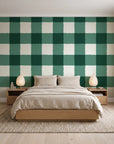 Dune Plaid Emerald gingham check wallpaper behind a low platform bed in a serene Japandi bedroom
