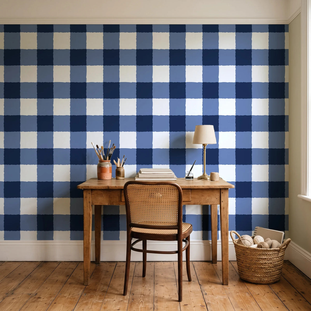 Dune Plaid Navy gingham check wallpaper behind a vintage writing desk in a cozy craft-room home office