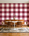 Dune Plaid Oxblood gingham check wallpaper in a mid-century dining room with a teak sideboard and tulip table