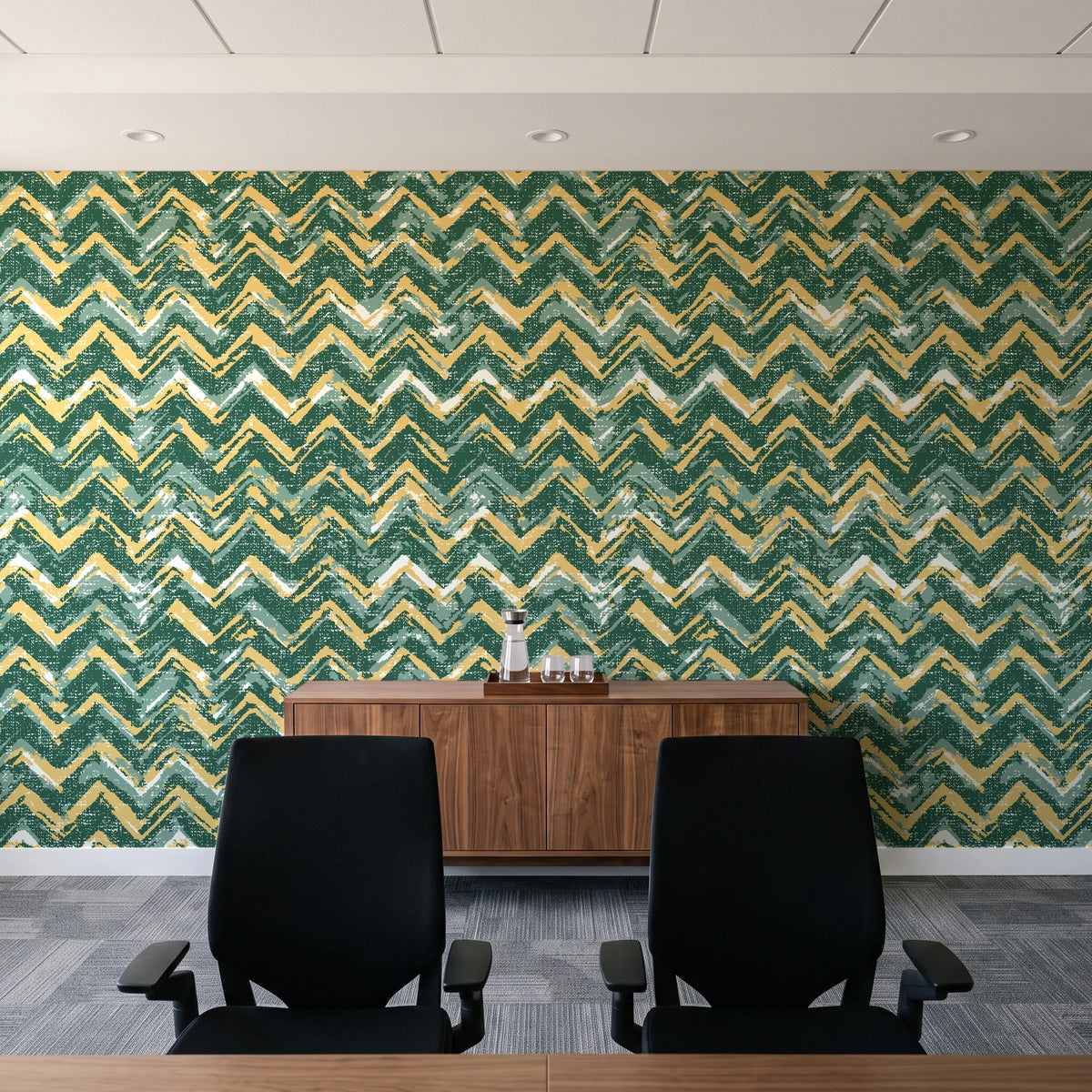 Dusk Passage Emerald chevron wallpaper above a walnut credenza in a modern conference room