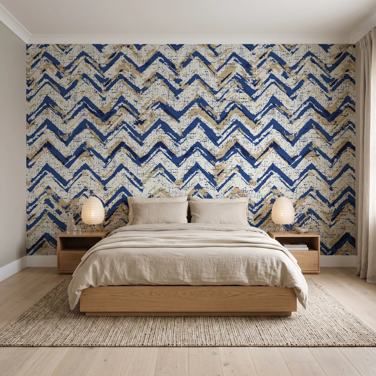 Dusk Passage Indigo chevron wallpaper behind a low platform bed in a serene Japandi bedroom