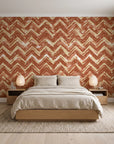 Dusk Passage Terracotta chevron wallpaper behind a low platform bed in a serene Japandi bedroom