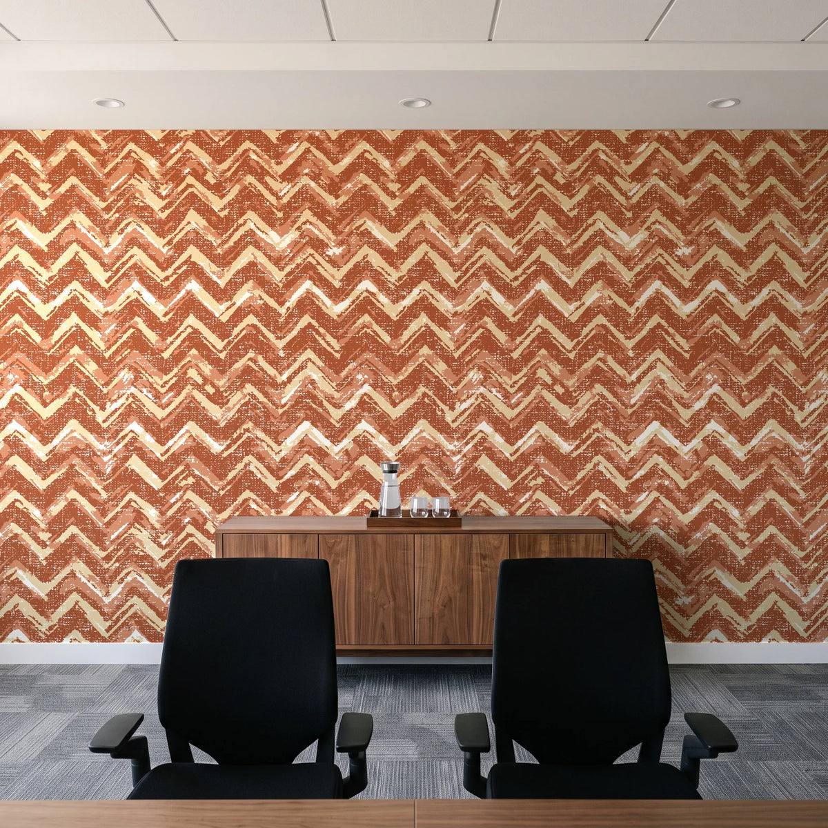 Dusk Passage Terracotta chevron wallpaper above a walnut credenza in a modern conference room