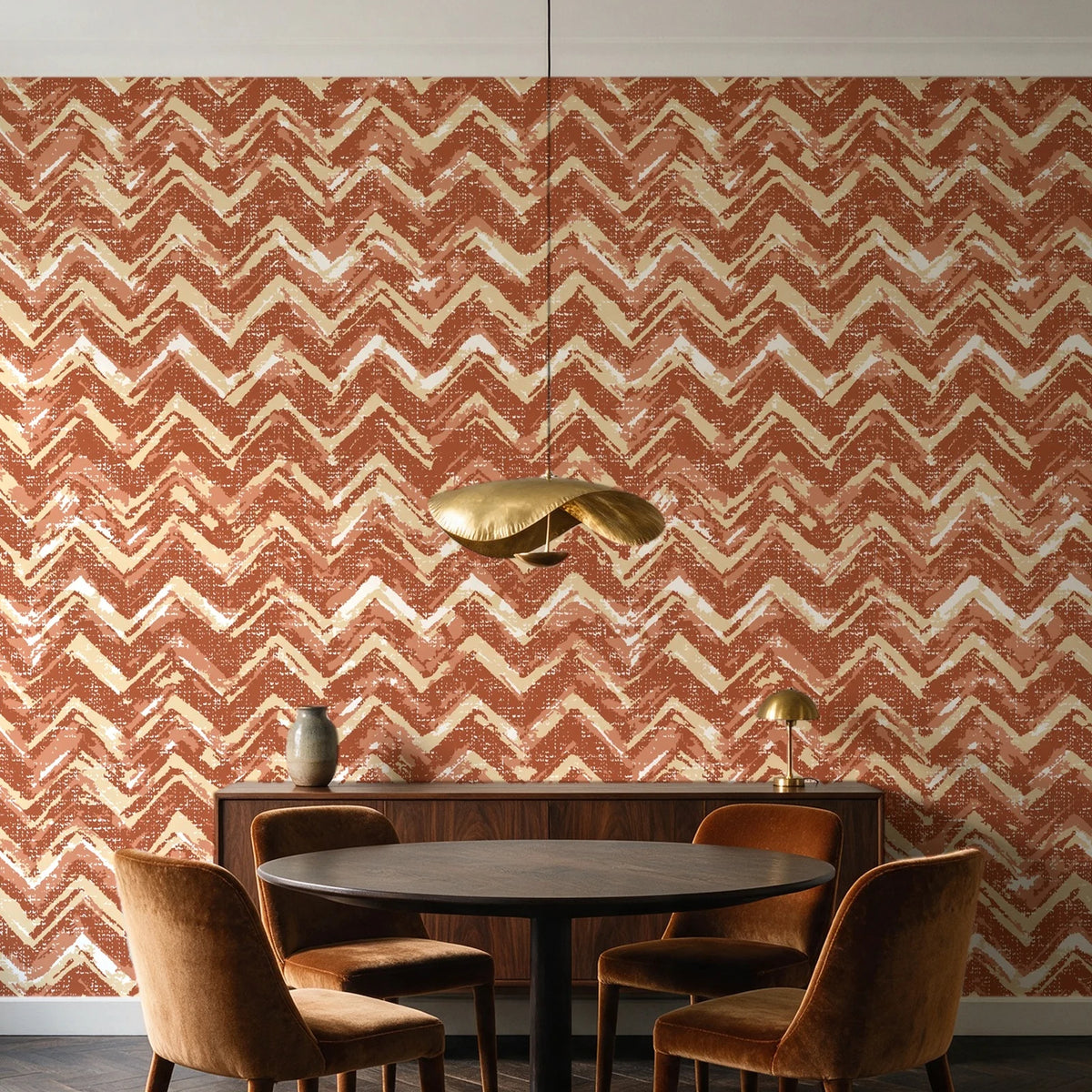 Dusk Passage Terracotta chevron wallpaper behind a walnut credenza and round table in an elegant dining room