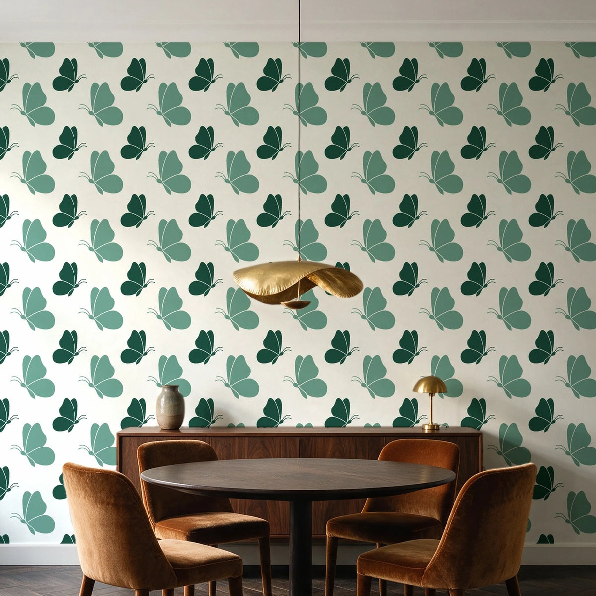 Dust & Wing Emerald butterflies wallpaper behind a walnut credenza and round table in an elegant dining room
