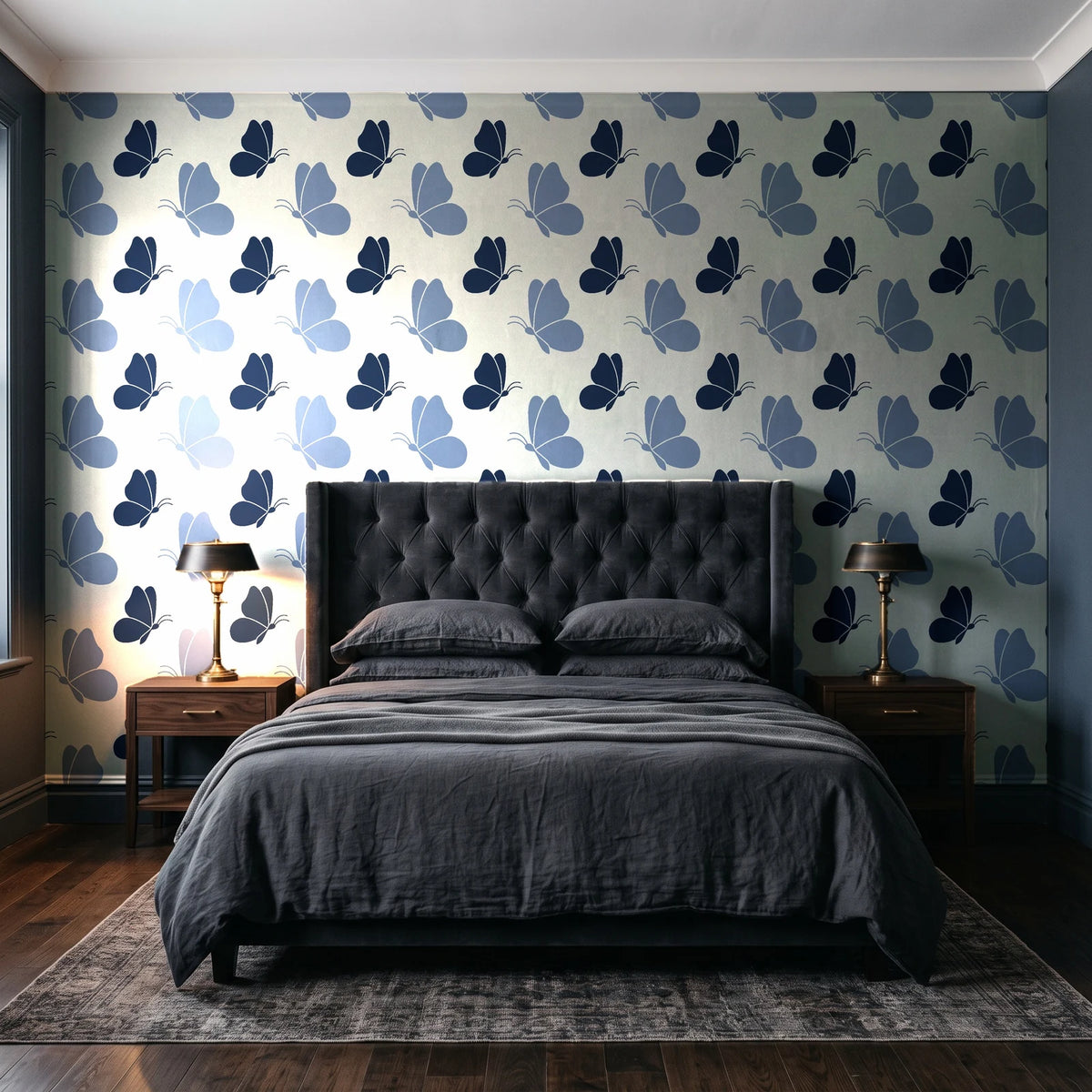 Dust & Wing Navy butterflies wallpaper behind a tufted headboard in a dark, moody bedroom